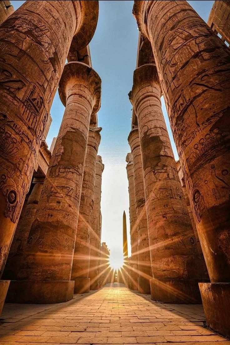 Karnak Temple in Luxor, Egypt — ancient columns and hieroglyphs under blue sky.